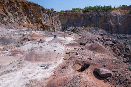 View of quarry open pit mining of granite stone. Process production stone and gravel. Heaps of rock...