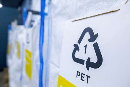 Sorting recyclables. The sorted polyethylene terephthalate (PET) plastic, is placed in a container with the appropriate marking.の写真素材