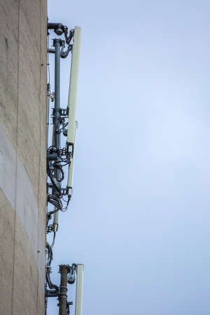 Telecommunication equipment (receivers and transmitters) of mobile network and Internet located on a reinforced concrete wall of a large industrial facility.の写真素材