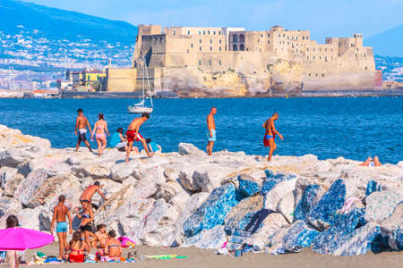 Naples, Italy - may 27: Summer day on the Mediterranean coast. People relax, sunbathe and swim on Mappatella Beach on Quay of Via Francesco Caracciolo. May 27, 2012. Naples, Campania, Italy.のeditorial素材