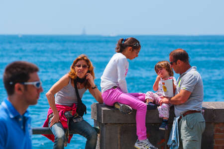 Naples, Italy - may 27: Summer day on the Mediterranean coast. People relax, sunbathe and swim on Mappatella Beach on Quay of Via Francesco Caracciolo. May 27, 2012. Naples, Campania, Italy.のeditorial素材