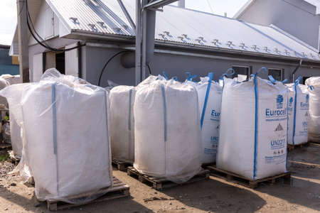 Kolomyia, Ukraine - SEP 04, 2020: Expandable Polystyrene Eurocell 200FL spherical beads in big-bag packages bulk of 1125 kg by Ravago stacked near the composition of chemical and construction mixturesのeditorial素材