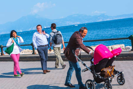 Naples, Italy - may 27: Summer day on the Mediterranean coast. People relax walking, sunbathe and just enjoy life at the seafront. May 27, 2012. Naples, Campania, Italy.のeditorial素材