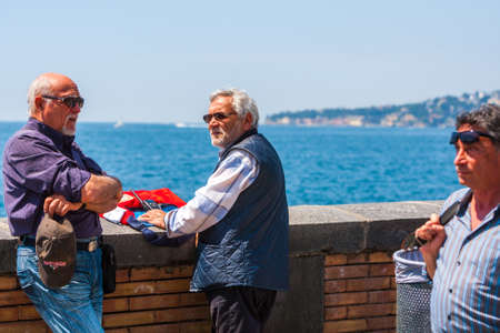 Naples, Italy - may 27: Summer day on the Mediterranean coast. People relax walking, sunbathe and just enjoy life at the seafront. May 27, 2012. Naples, Campania, Italy.のeditorial素材