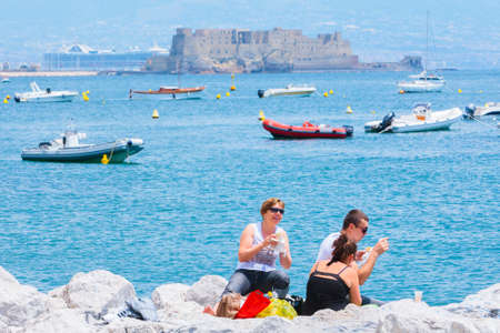 Naples, Italy - may 27: Summer day on the Mediterranean coast. People relax walking, sunbathe and just enjoy life at the seafront. May 27, 2012. Naples, Campania, Italy.のeditorial素材