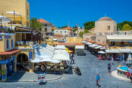 Rhodes, Greece - June 29, 2021: sightseeing place at hot summer sunshine afternoon. Tourists at the intersection Aristotle Str\Socrates Str- Hippocrates square at the Rhodes old town of Rhodes, Greeceのeditorial素材