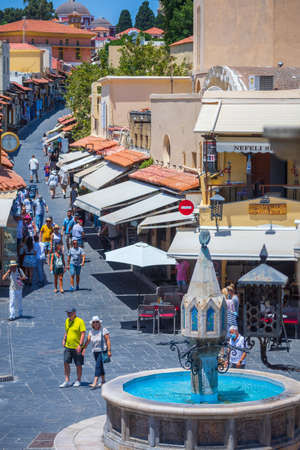 Rhodes, Greece - June 29, 2021: sightseeing place at hot summer sunshine afternoon. Tourists at the intersection Aristotle Str\Socrates Str- Hippocrates square at the Rhodes old town of Rhodes, Greeceのeditorial素材