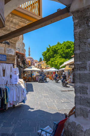 Rhodes, Greece - July 04, 2021: sightseeing place at hot summer sunshine afternoon. Socrates str in Old Rhodes Town - street market  with shops, restaurants, and hundreds of tourists and vacationers.のeditorial素材