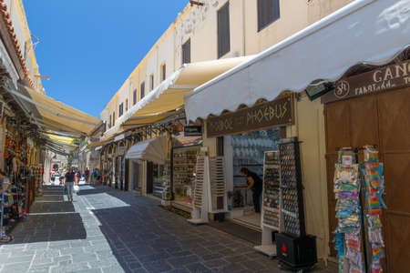 Rhodes, Greece - June 28, 2021: sightseeing place at hot summer sunshine afternoon. Socrates str in Old Rhodes Town - street market  with shops, restaurants, and hundreds of tourists and vacationers.のeditorial素材