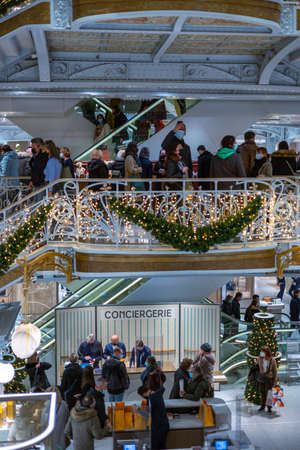 Paris, France - DEC 04, 2021: People shopping in the luxury mall La Samaritaine department store....