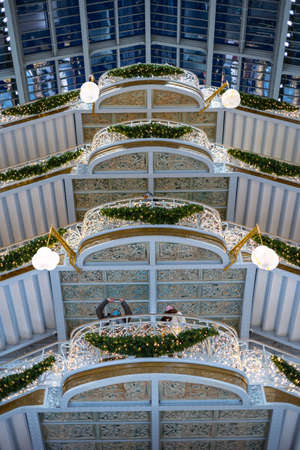 Paris, France - DEC 04, 2021: People shopping in the luxury mall "La Samaritaine" department store. Inside the building Christmas atmosphere and decorations in Paris France, December 04, 2021のeditorial素材