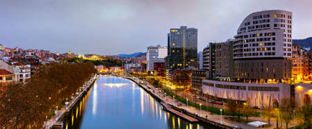 Awesome evening autumn panoramic cityscape view of embankment Estuary of Bilbao. Bilbao, Biscay, Basque country - warm winter in Spain.の写真素材