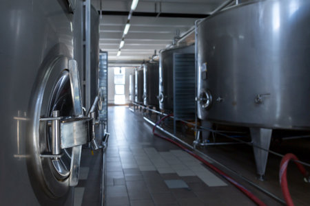 Stainless steel barrels and tanks and other containers for liquids in the food industry. Industrial production of alcoholic or soft drinks.の写真素材