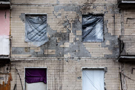 KYIV, UKRAINE - APR 21, 2022: The facade of an apartment building on Koshytsia str. was destroyed by...