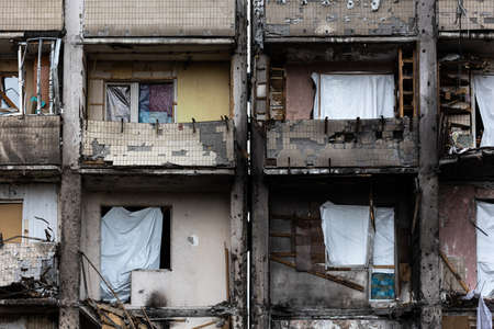 KYIV, UKRAINE - APR 21, 2022: The facade of an apartment building on Koshytsia str. was destroyed by...