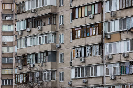 KYIV, UKRAINE - APR 21, 2022: The facade of an apartment building on Koshytsia str. was destroyed by the Kalibr cruise missile on the second day of the full-scale Russian invasion of Ukraine.のeditorial素材