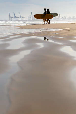 Summer atmosphere on the sunny autumn beach of Malvarrosa in Valencia, Spain. The sea coast attracts...