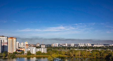 KYIV, UKRAINE - JULY 28 2022: Smoke rises over the city skyline after Russian ballistic missile strikes from the territory of Belarus on the outskirts Ukrainian capital in the Vyshhorod district.のeditorial素材