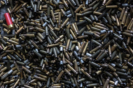 on the floor in the shooting range there are casings from fired cartridges of various calibers -...