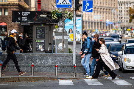 Kyiv, Ukraine - OCT 01, 2022: People, residents and guests, at warm autumn weekend on the streets of the capital stroll in the historical center and go shopping. A everyday street life in a big city.のeditorial素材