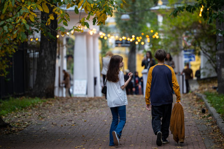 Kyiv, Ukraine - OCT 01, 2022: People, residents and guests, at warm autumn weekend on the streets of the capital stroll in the historical center and go shopping. A everyday street life in a big city.のeditorial素材