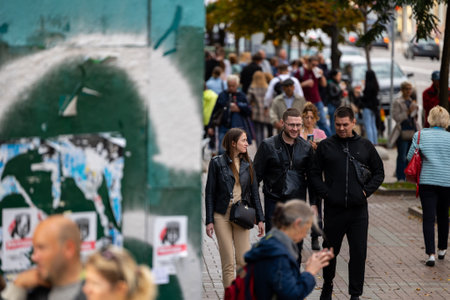 Kyiv, Ukraine - OCT 01, 2022: People, residents and guests, at warm autumn weekend on the streets of the capital stroll in the historical center and go shopping. A everyday street life in a big city.のeditorial素材