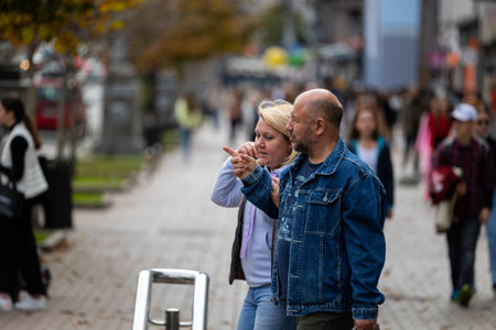 Kyiv, Ukraine - OCT 01, 2022: People, residents and guests, at warm autumn weekend on the streets of the capital stroll in the historical center and go shopping. A everyday street life in a big city.のeditorial素材