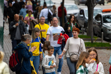 Kyiv, Ukraine - OCT 01, 2022: People, residents and guests, at warm autumn weekend on the streets of...