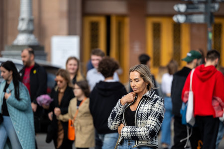 Kyiv, Ukraine - OCT 01, 2022: People, residents and guests, at warm autumn weekend on the streets of the capital stroll in the historical center and go shopping. A everyday street life in a big city.のeditorial素材