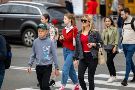 Kyiv, Ukraine - OCT 01, 2022: People, residents and guests, at warm autumn weekend on the streets of the capital stroll in the historical center and go shopping. A everyday street life in a big city.のeditorial素材