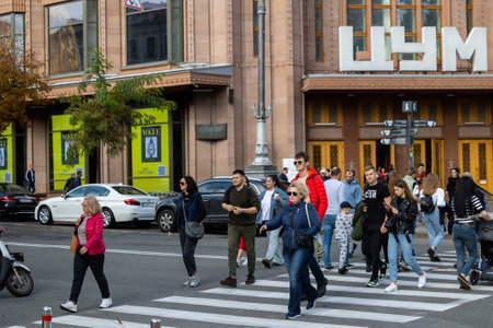 Kyiv, Ukraine - OCT 01, 2022: People, residents and guests, at warm autumn weekend on the streets of the capital stroll in the historical center and go shopping. A everyday street life in a big city.のeditorial素材