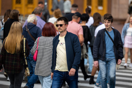 Kyiv, Ukraine - OCT 01, 2022: People, residents and guests, at warm autumn weekend on the streets of the capital stroll in the historical center and go shopping. A everyday street life in a big city.のeditorial素材