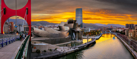 Bilbao, Spain - NOV 20, 2021: awesome evening panoramic view of The Guggenheim Museum designed by Frank Gehry and embankment Estuary of Bilbao and skyscraper of energy company IBERDROLAのeditorial素材