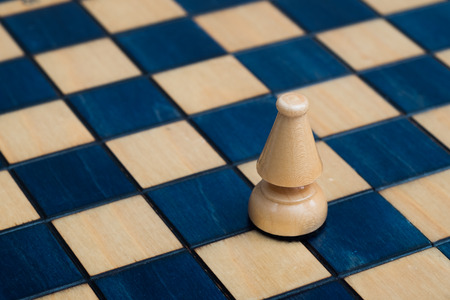 White bishop on wooden chessboardの写真素材