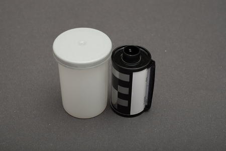 Film canister 35mm on black backgroundの写真素材