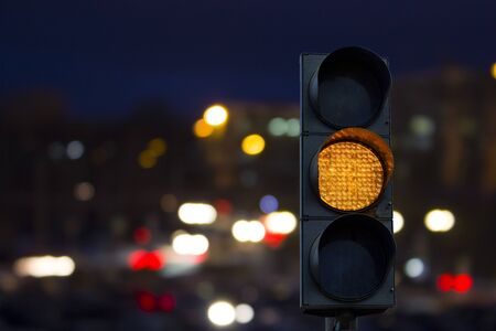Traffic light yellow signal background night cityの写真素材
