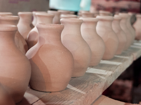 clay pots on a shelf in the pottery workshopの写真素材