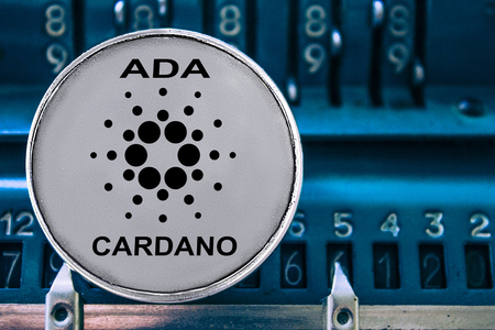 Coin of Cardano on the background of numbers adding machine. The concept of production or rate of ada.の写真素材
