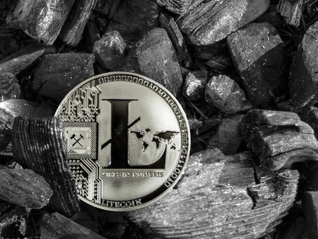 The cryptocurrency Litecoin coin lies on coal. Mining and Energy for mining.