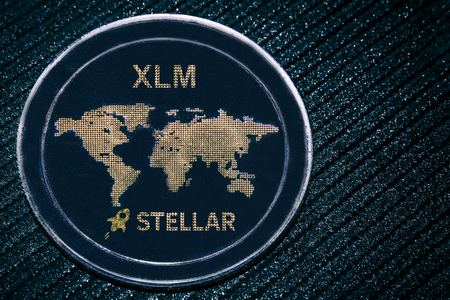 Coin cryptocurrency XLM on a grey shiny background. Stellar.
