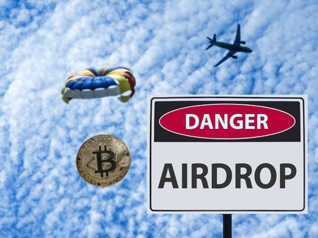 the sign danger airdrop and Coin bitcoin is flying on a parachute from the plane. Airdrop token.