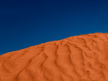 Ripples of red sand in the desert and blue sky.の写真素材
