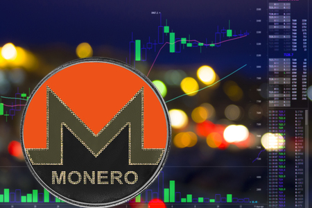 Coin cryptocurrency Monero on night city background and chart. XMRの写真素材