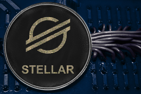 The coin cryptocurrency Stellar on the background of wires and circuits. Token XLM.の写真素材