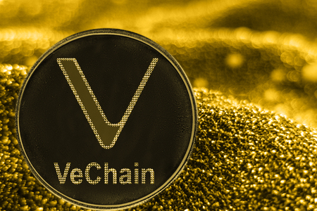 Coin cryptocurrency VET VeChain and gold fabric background.の写真素材