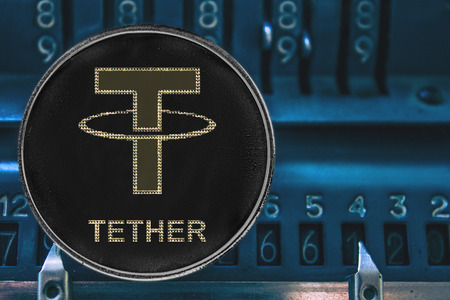 Coin cryptocurrency Tether and the numbers of the arithmometer. The concept of USDT token.の写真素材