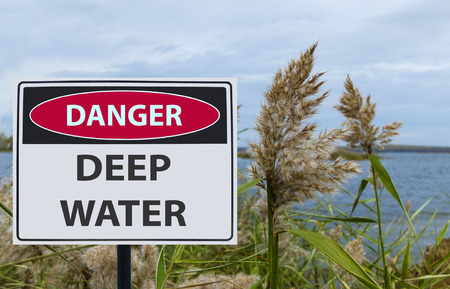 the sign danger deep water on the shore of the reservoirの写真素材