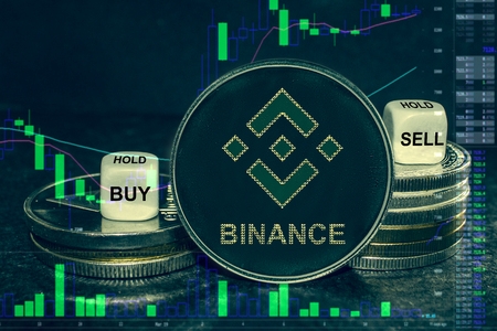 The coin cryptocurrency bnb binance stack of coins and dice. Exchange chart to buy, sell, hold.の写真素材