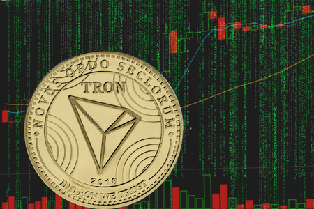 Coin tron trx cryptocurrency on the background of binary crypto matrix text and price chart.の写真素材