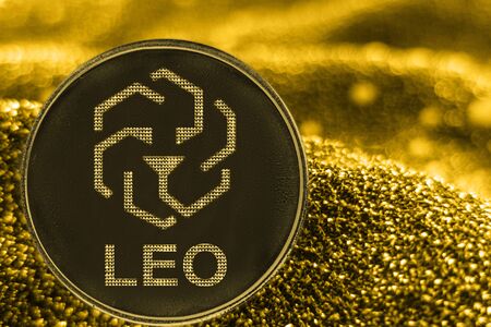 Coin cryptocurrency Leo and gold fabric background. bifinex token logo.の写真素材